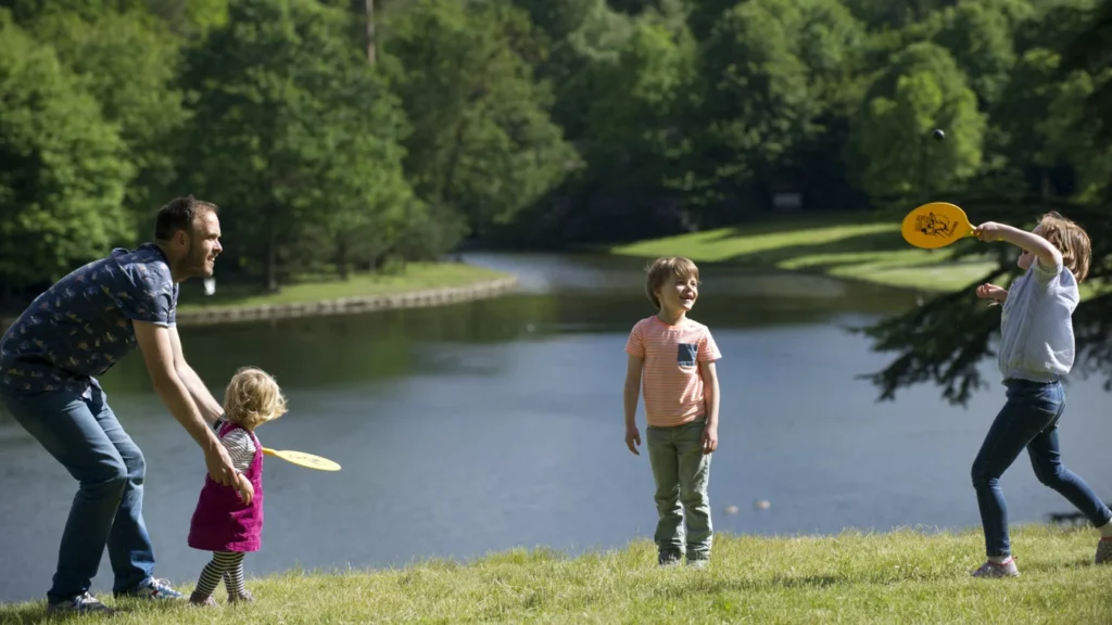 family-playing-lake-claremont-landscape-garden-surrey