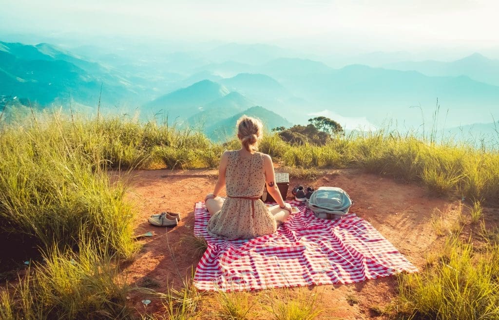 Woman enjoying a picnic, just like people do at venues in Surrey